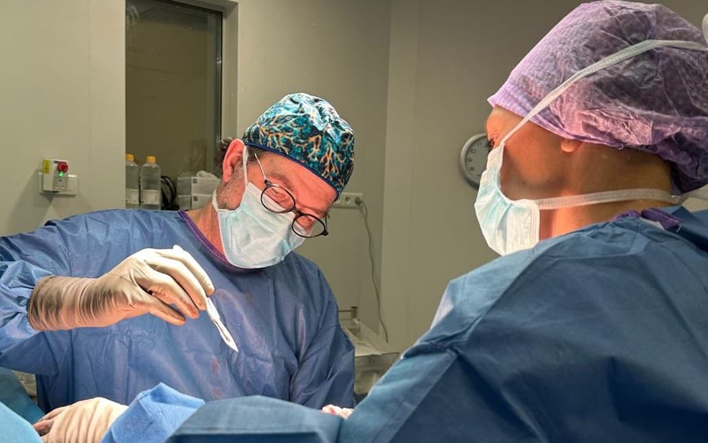 Dr Azencot in the operating theatre, under binocular loupes